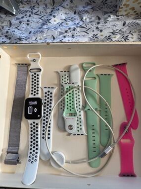 Apple 5 Series Watch with White/Black Sport Band and Mint, Pink, Silver Bands